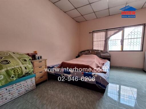 Bedroom with bed, nightstand, and window