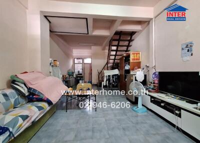 A spacious living room with furniture and a staircase