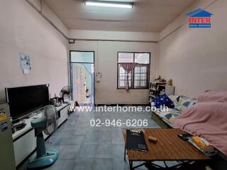 Living room with furniture, TV, and fan