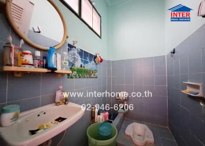 Bathroom with basin, mirror, window, and traditional squat toilet