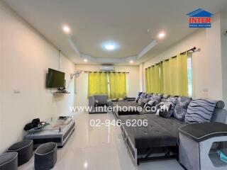 Modern living room with large sofa and wall-mounted TV