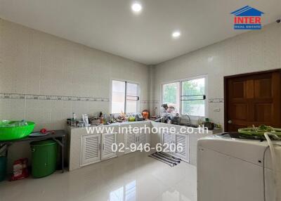 Photo of a kitchen with various kitchen appliances and fixtures