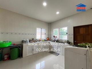 Photo of a kitchen with various kitchen appliances and fixtures