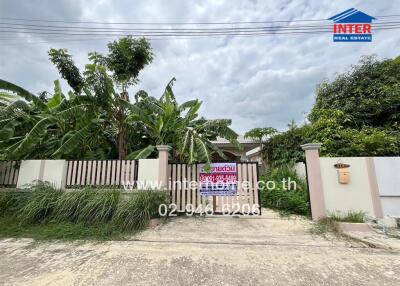 Exterior view of a property with garden and driveway