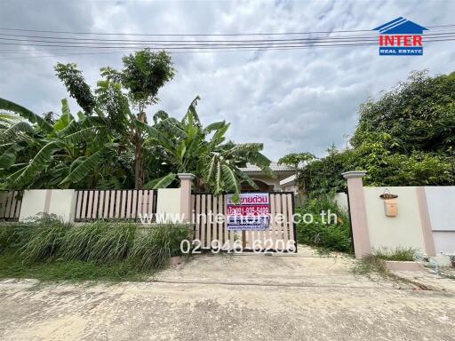 Exterior view of a property with garden and driveway