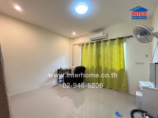 Bedroom with desk, air conditioner, and green curtains