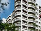 Exterior view of a multi-story residential building with curved balconies