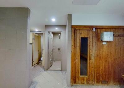 Hallway with wooden door and tiles