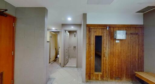 Hallway with wooden door and tiles