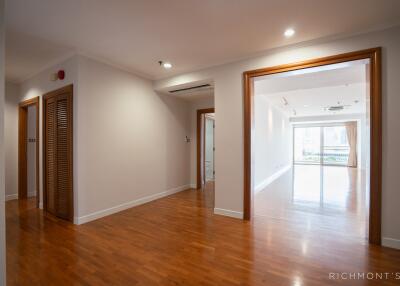 Spacious and well-lit living area with wooden flooring