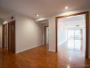 Spacious and well-lit living area with wooden flooring