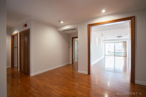 Spacious and well-lit living area with wooden flooring