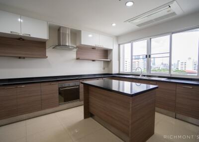 Modern kitchen with island, large windows, and built-in appliances