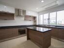 Modern kitchen with island, large windows, and built-in appliances