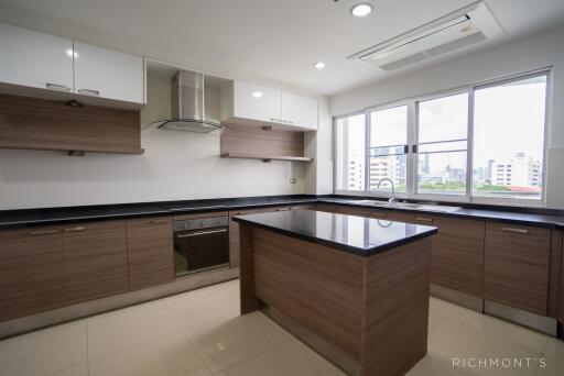 Modern kitchen with island, large windows, and built-in appliances