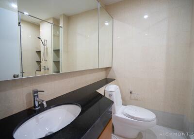 Modern bathroom with a large mirror and a walk-in shower