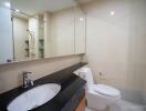 Modern bathroom with a large mirror and a walk-in shower