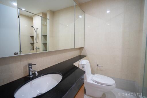 Modern bathroom with a large mirror and a walk-in shower