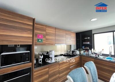 Modern kitchen with wooden cabinetry and appliances