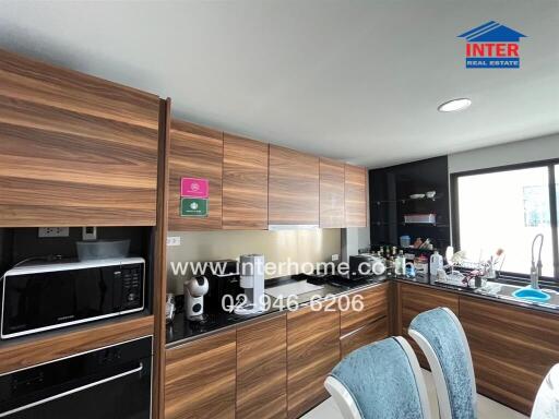 Modern kitchen with wooden cabinetry and appliances