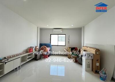 Spacious living room with bright white walls and floor