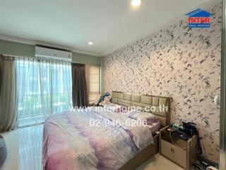 Bedroom with large window, bed, and air conditioning unit