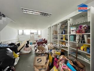 Cluttered storage room with shelves and various items