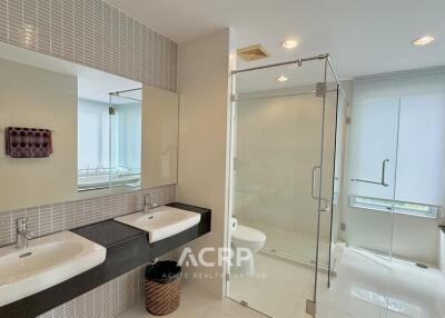 modern bathroom with double sinks and glass shower