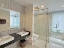 modern bathroom with double sinks and glass shower