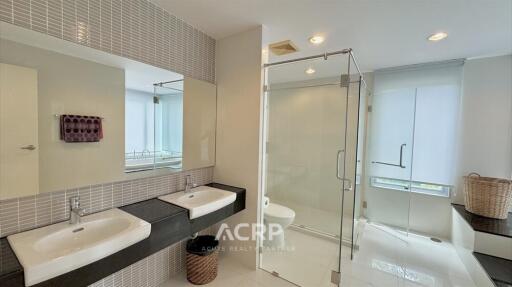 modern bathroom with double sinks and glass shower