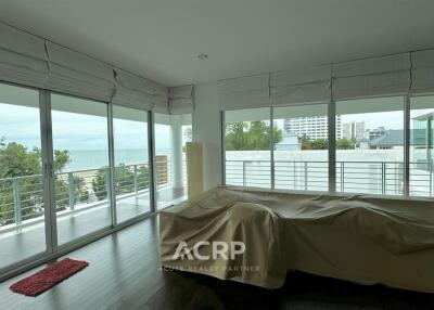 Spacious bedroom with large windows and ocean view