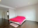 Spacious bedroom with a red bedspread