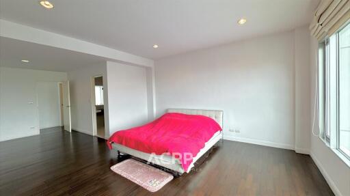 Spacious bedroom with a red bedspread