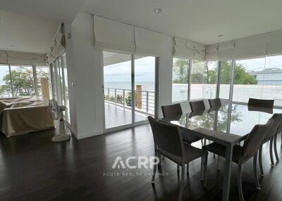 Modern living area with dining table and large windows