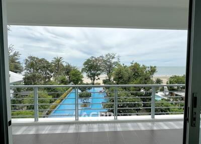 View from balcony overlooking pool and ocean