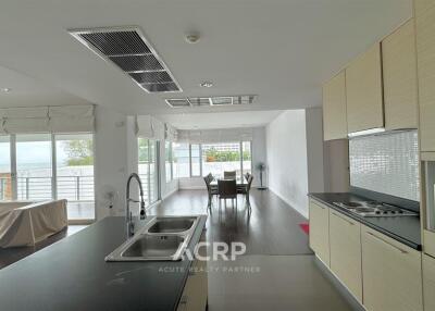 Spacious modern kitchen and living area with large windows and dining space