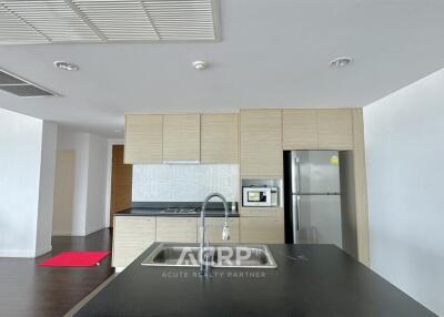 Modern kitchen with wooden cabinets and stainless steel appliances