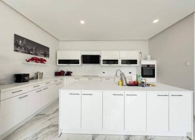 Modern kitchen with white cabinets and appliances