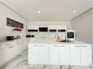 Modern kitchen with white cabinets and appliances