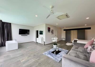 Spacious modern living room with sofa, entertainment center, and TV