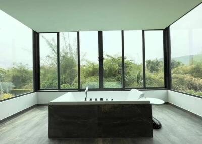 Spacious bathroom with large windows and a bathtub