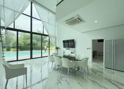 Modern dining area with large windows and pool view