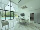 Modern dining area with large windows and pool view