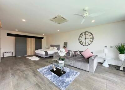 Spacious and modern living room with a clock on the wall