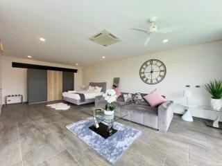 Spacious and modern living room with a clock on the wall