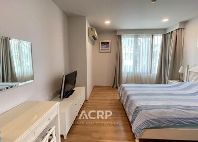 Bedroom with bed, TV, and window