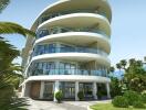 Modern curved apartment building with large windows