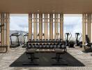 Modern gym with various exercise equipment and a scenic view