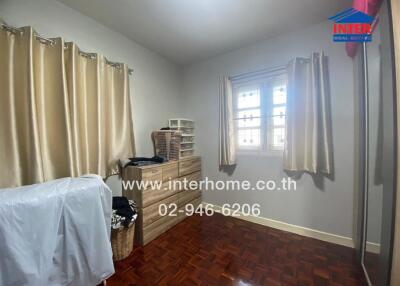 Bedroom with parquet flooring and natural light