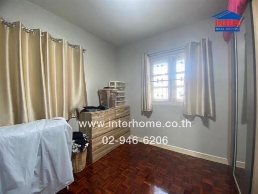 Bedroom with parquet flooring and natural light